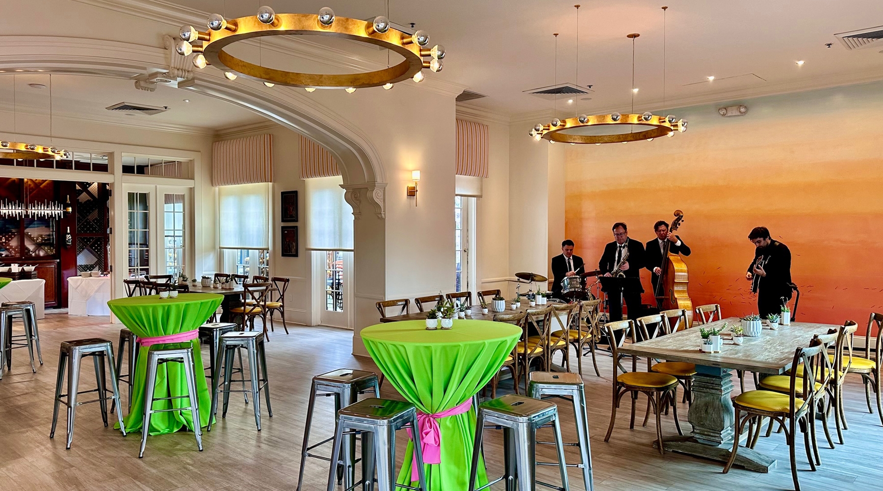 Tables and seating area in event room with band