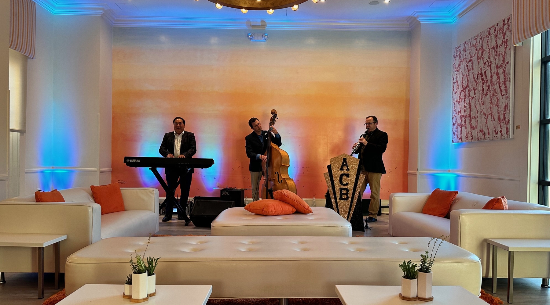 Tables and seating area in event room with band